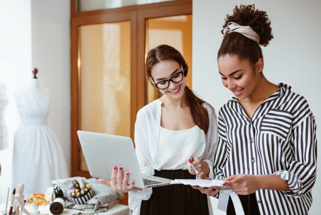 Two young attractive women working on new design project